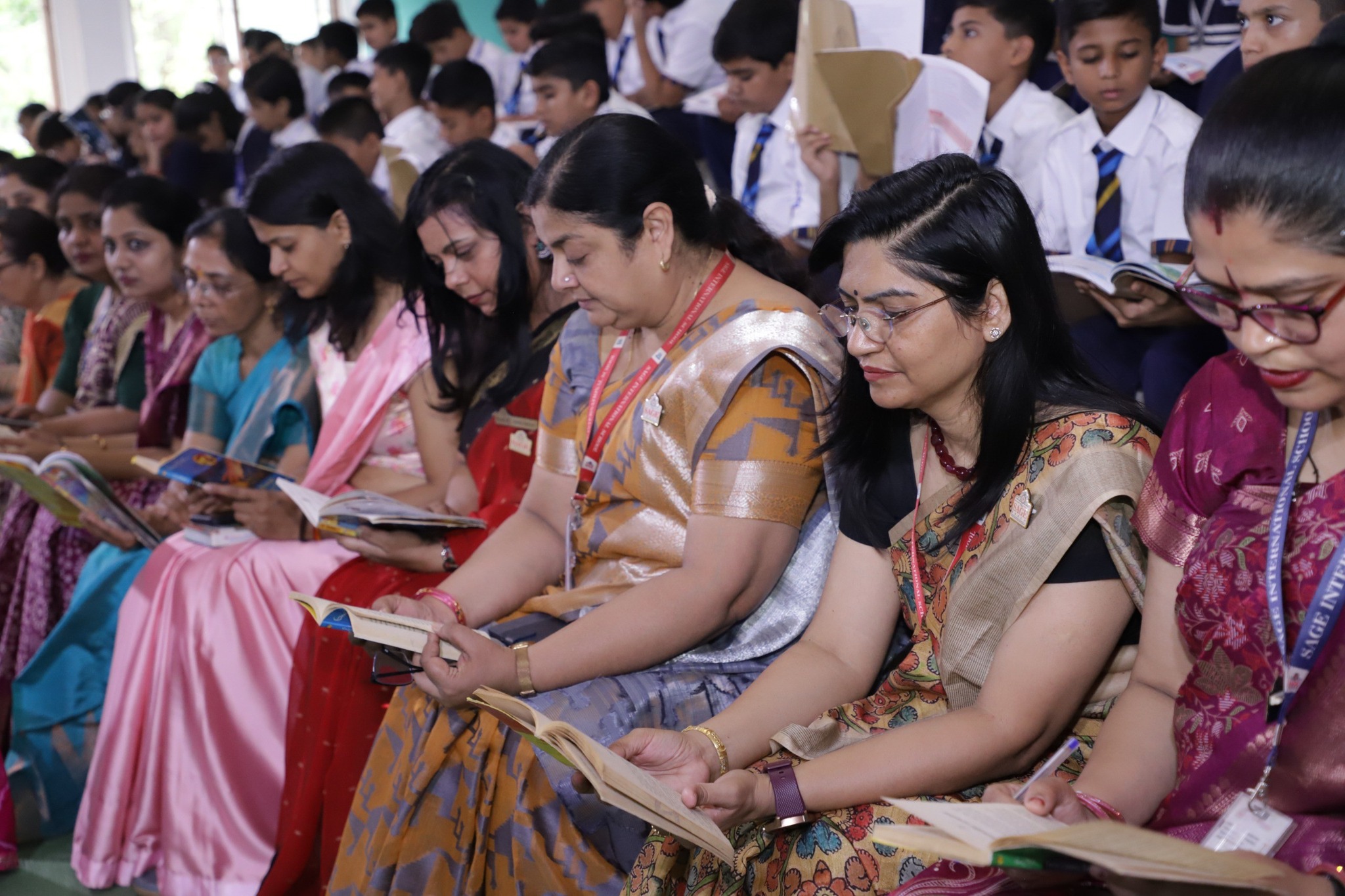 teachers and kid reading books